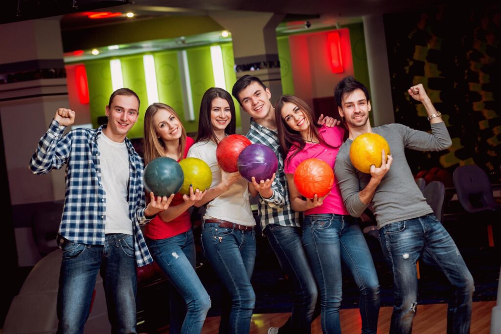 cheerful friends bowling alley balls
