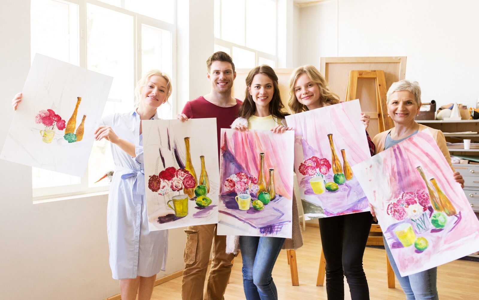 group of artists with pictures at art school